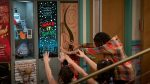 "A group of people reach toward a glowing locker with a "MAKE IT SHINE" sign in a school hallway, colorful environment, lockers, and decorations visible around them."