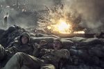 "Two soldiers in combat uniforms take cover behind sandbags as an explosion erupts nearby on a smoky, chaotic battlefield, with flames and debris filling the air."