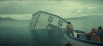 "A partially submerged house tilts in a misty lake as three people in a small boat observe, with cloudy skies and distant hills creating a dramatic, mysterious atmosphere."